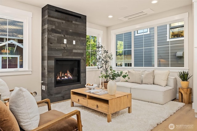 10511 NE 112th St, Kirkland, WA 98033 - living room with a large fireplace, wood finished floors, and recessed lighting