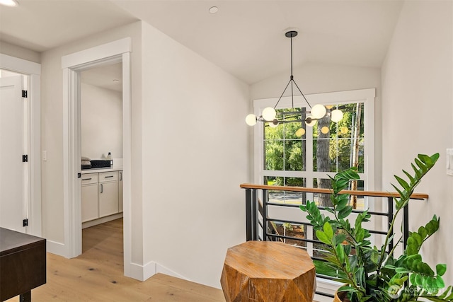 10511 NE 112th St, Kirkland, WA 98033 - hallway with light wood-style floors, a chandelier, and vaulted ceiling