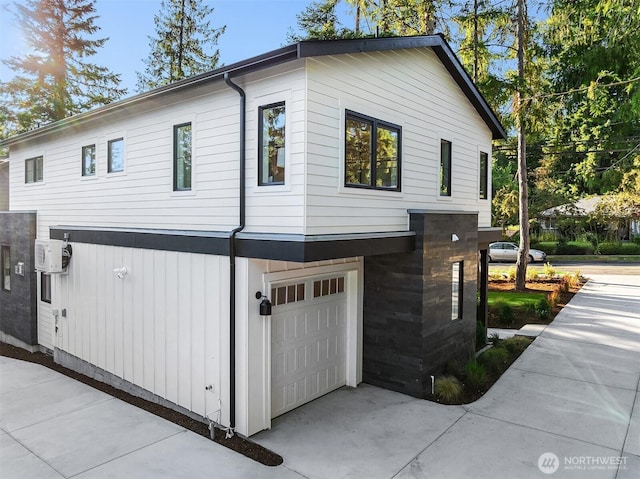 10511 NE 112th St, Kirkland, WA 98033 - view of property exterior featuring an attached garage and driveway