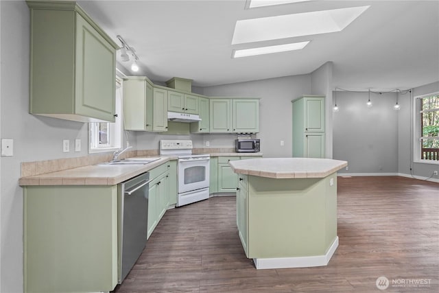 261 E Emerald Lake Dr W, Grapeview, WA 98546 - kitchen featuring appliances with stainless steel finishes, green cabinets, a kitchen island, dark wood-style flooring, and lofted ceiling