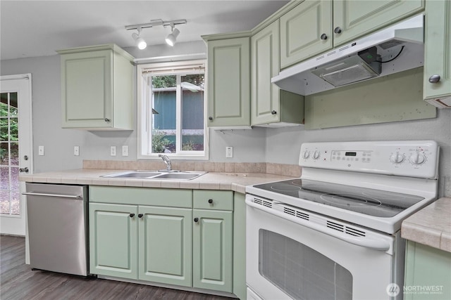 261 E Emerald Lake Dr W, Grapeview, WA 98546 - kitchen with electric range, stainless steel dishwasher, under cabinet range hood, and plenty of natural light