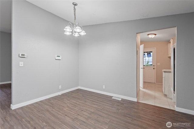 261 E Emerald Lake Dr W, Grapeview, WA 98546 - unfurnished room with wood finished floors and a chandelier
