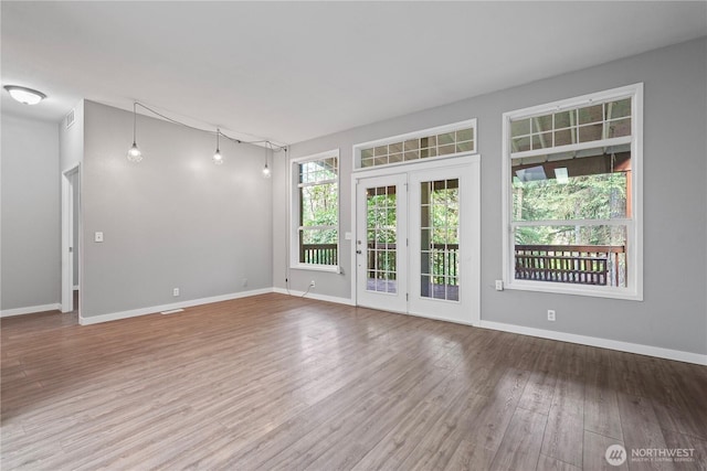 261 E Emerald Lake Dr W, Grapeview, WA 98546 - unfurnished room featuring wood finished floors and baseboards