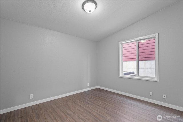 261 E Emerald Lake Dr W, Grapeview, WA 98546 - spare room with vaulted ceiling and dark wood-style floors