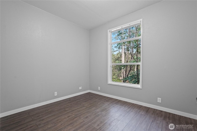 261 E Emerald Lake Dr W, Grapeview, WA 98546 - spare room featuring dark wood-type flooring and baseboards