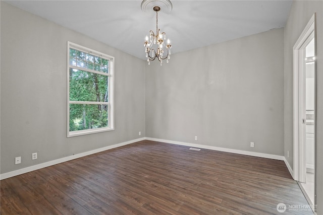 261 E Emerald Lake Dr W, Grapeview, WA 98546 - unfurnished room featuring a chandelier and dark wood-type flooring