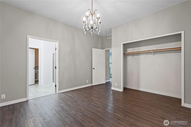 261 E Emerald Lake Dr W, Grapeview, WA 98546 - unfurnished bedroom featuring a chandelier, wood finished floors, and a closet