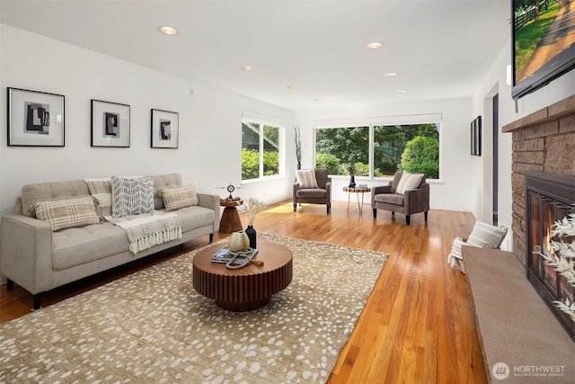 17905 3rd Ave NW, Shoreline, WA 98177 - living area featuring wood finished floors, a stone fireplace, and recessed lighting