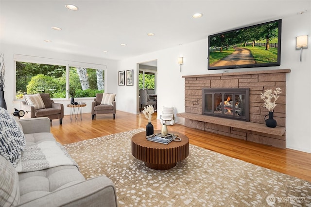 17905 3rd Ave NW, Shoreline, WA 98177 - living area featuring wood finished floors, recessed lighting, and a stone fireplace