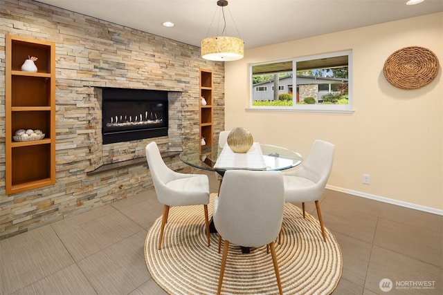 17905 3rd Ave NW, Shoreline, WA 98177 - dining area featuring built in features, tile patterned flooring, a fireplace, and recessed lighting