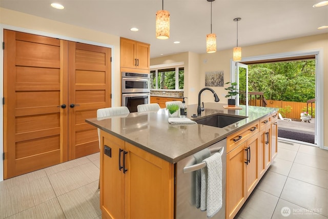 17905 3rd Ave NW, Shoreline, WA 98177 - kitchen with a center island with sink, stainless steel double oven, light tile patterned floors, recessed lighting, and decorative light fixtures