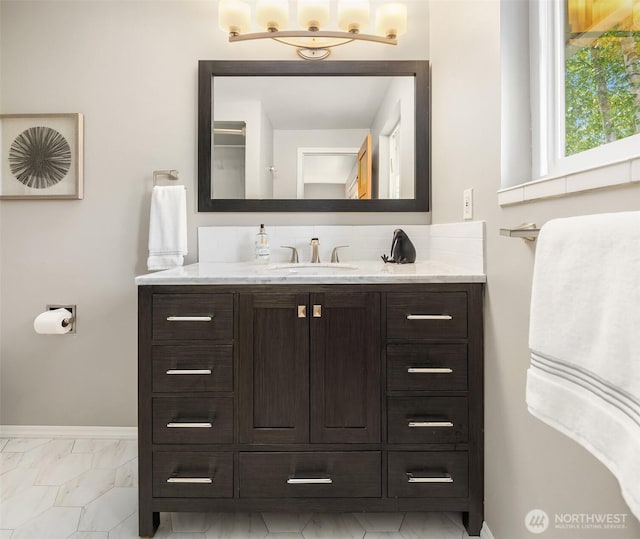 17905 3rd Ave NW, Shoreline, WA 98177 - bathroom with vanity, marble look tile flooring, and decorative backsplash