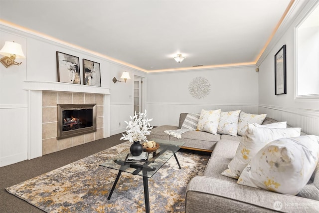 17905 3rd Ave NW, Shoreline, WA 98177 - carpeted living room with a tile fireplace, a decorative wall, crown molding, and wainscoting