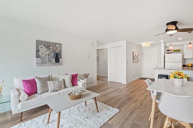 411 N 90th St Unit 406, Seattle, WA 98103 - living room featuring light wood finished floors and a ceiling fan