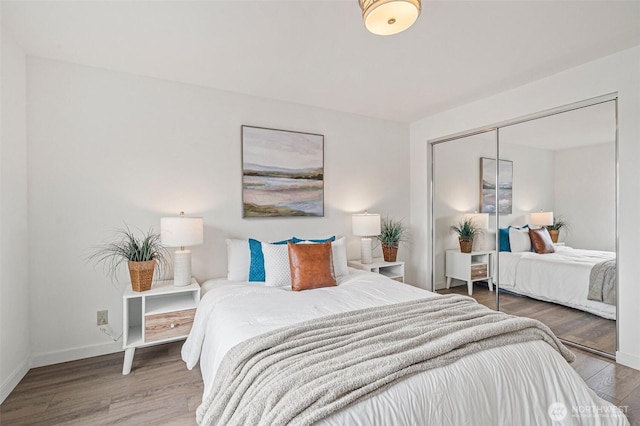 411 N 90th St Unit 406, Seattle, WA 98103 - bedroom with wood finished floors and a closet