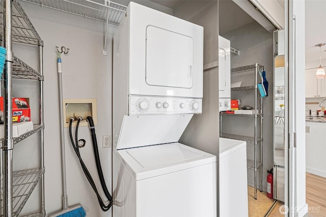 411 N 90th St Unit 406, Seattle, WA 98103 - laundry area with estacked washer and dryer and light wood finished floors