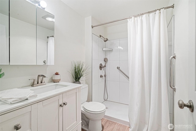 411 N 90th St Unit 406, Seattle, WA 98103 - full bathroom with vanity, a shower with shower curtain, and wood finished floors