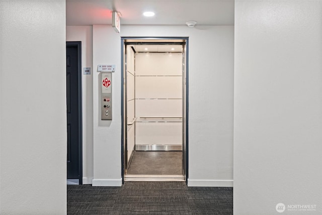 411 N 90th St Unit 406, Seattle, WA 98103 - hallway with baseboards and dark colored carpet
