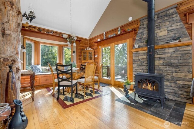 793 E Stadium Beach Rd W, Grapeview, WA 98546 - dining area featuring a wood stove, light wood finished floors, plenty of natural light, and high vaulted ceiling