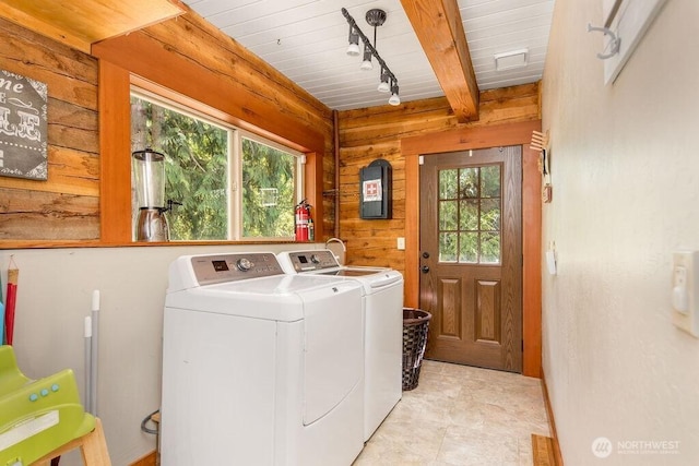 793 E Stadium Beach Rd W, Grapeview, WA 98546 - laundry room featuring washing machine and dryer, wood walls, healthy amount of natural light, and track lighting