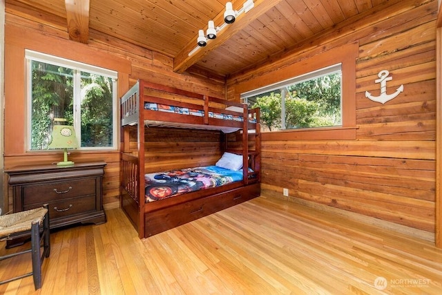 793 E Stadium Beach Rd W, Grapeview, WA 98546 - bedroom featuring multiple windows, a wooden ceiling with exposed beams, wooden walls, light wood-type flooring, and track lighting