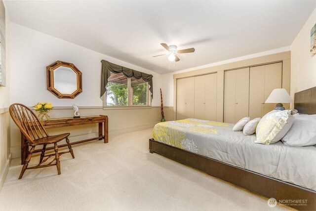 793 E Stadium Beach Rd W, Grapeview, WA 98546 - bedroom featuring carpet flooring, two closets, and ceiling fan