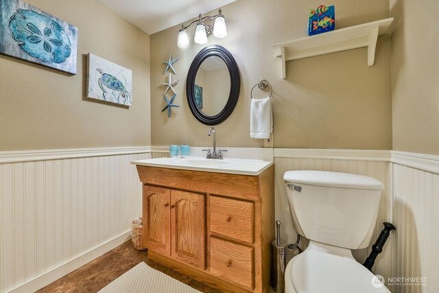 793 E Stadium Beach Rd W, Grapeview, WA 98546 - bathroom featuring vanity and a wainscoted wall