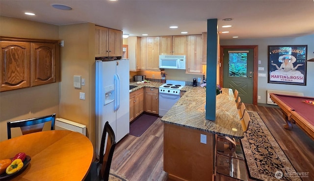 755 Ferry Rd, Lopez Island, WA 98261 - kitchen featuring white appliances, dark wood finished floors, a peninsula, light stone counters, and recessed lighting