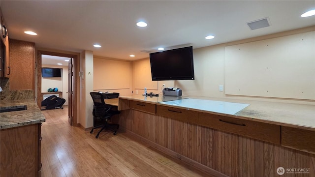 755 Ferry Rd, Lopez Island, WA 98261 - kitchen featuring light wood-type flooring, brown cabinetry, recessed lighting, and light countertops