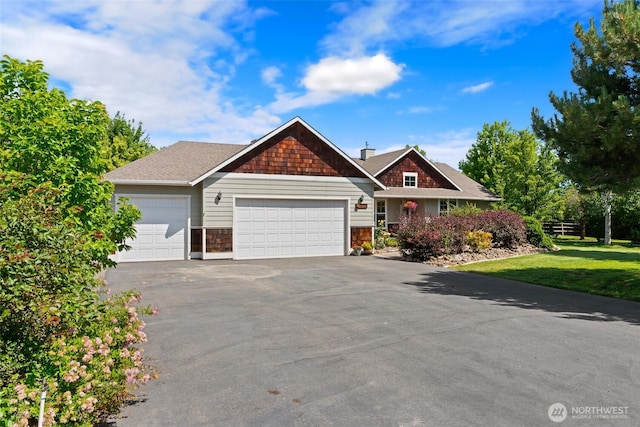 321 Range View Rd, Ellensburg, WA 98926 - view of front of property featuring a garage, asphalt driveway, and a front lawn