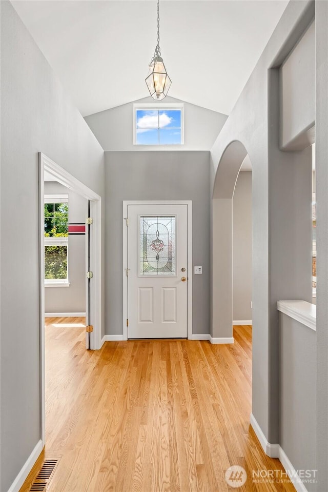 321 Range View Rd, Ellensburg, WA 98926 - foyer entrance featuring a chandelier, arched walkways, light wood-style flooring, and vaulted ceiling