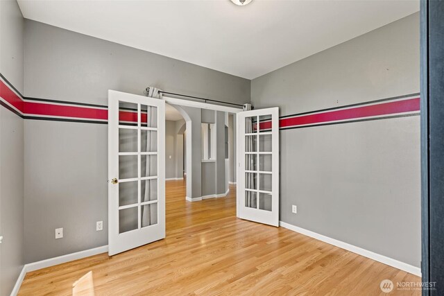 321 Range View Rd, Ellensburg, WA 98926 - spare room featuring french doors, wood finished floors, and arched walkways