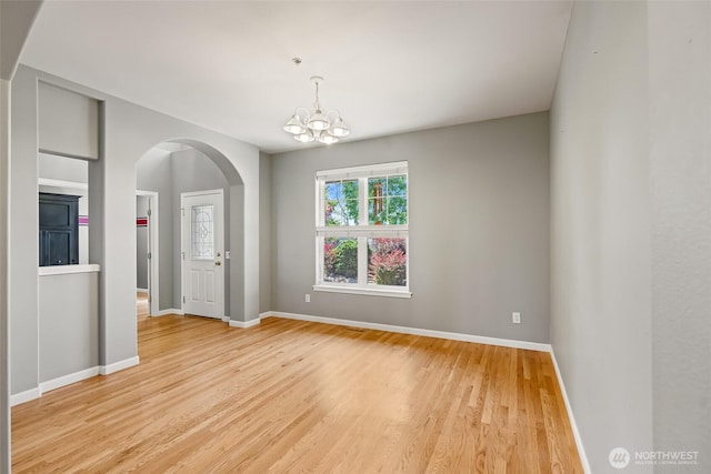 321 Range View Rd, Ellensburg, WA 98926 - unfurnished room featuring arched walkways, light wood-type flooring, and a chandelier