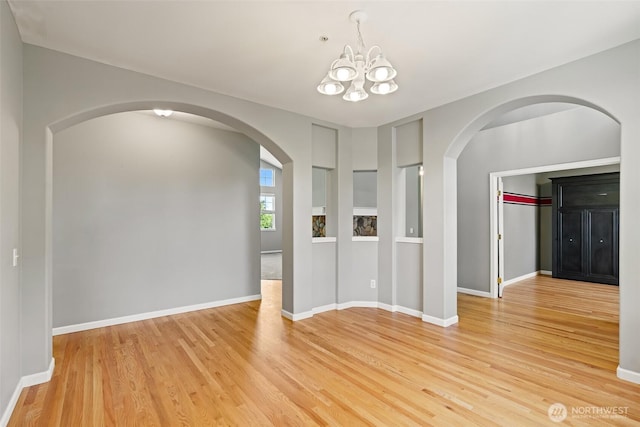 321 Range View Rd, Ellensburg, WA 98926 - unfurnished room with arched walkways, light wood finished floors, and a chandelier