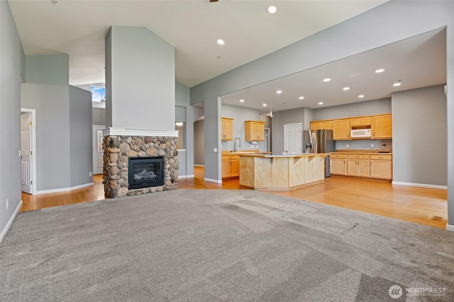 321 Range View Rd, Ellensburg, WA 98926 - unfurnished living room with light wood finished floors, a stone fireplace, recessed lighting, and high vaulted ceiling