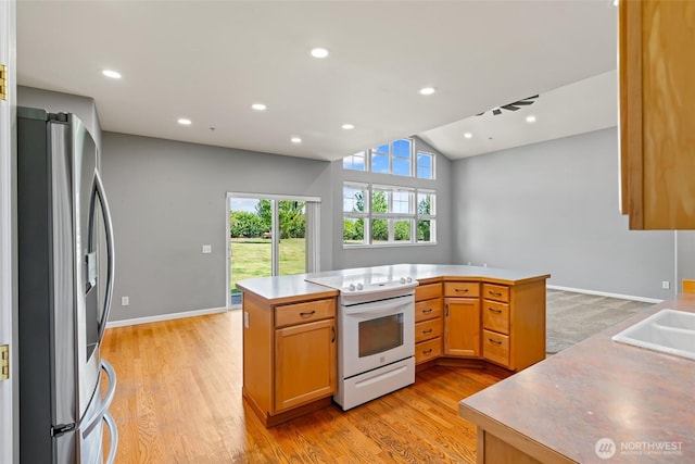 321 Range View Rd, Ellensburg, WA 98926 - kitchen with stainless steel refrigerator with ice dispenser, white electric range, light wood-style flooring, light countertops, and lofted ceiling