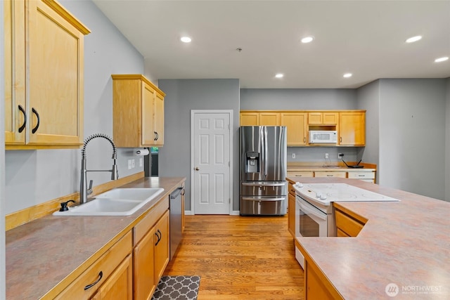 321 Range View Rd, Ellensburg, WA 98926 - kitchen featuring appliances with stainless steel finishes, light wood-style floors, recessed lighting, light brown cabinetry, and light countertops