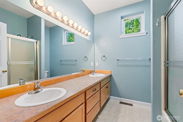 321 Range View Rd, Ellensburg, WA 98926 - full bathroom featuring healthy amount of natural light, a shower with door, double vanity, and tile patterned floors