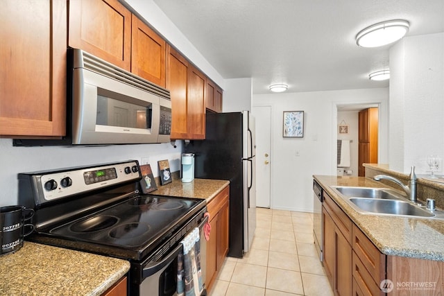300 10th Ave Unit B310, Seattle, WA 98122 - kitchen with appliances with stainless steel finishes, brown cabinets, and light tile patterned floors