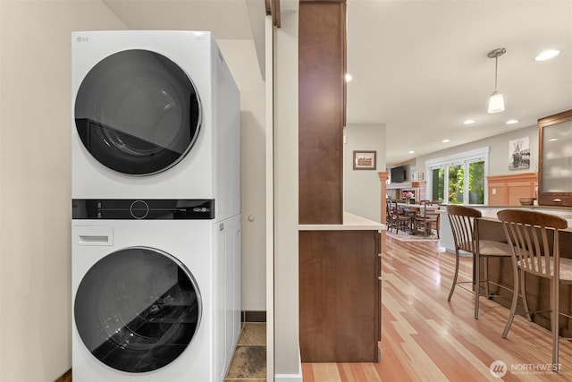 1605 Donovan Ave, Bellingham, WA 98225 - washroom with stacked washer and clothes dryer, light wood-type flooring, and recessed lighting