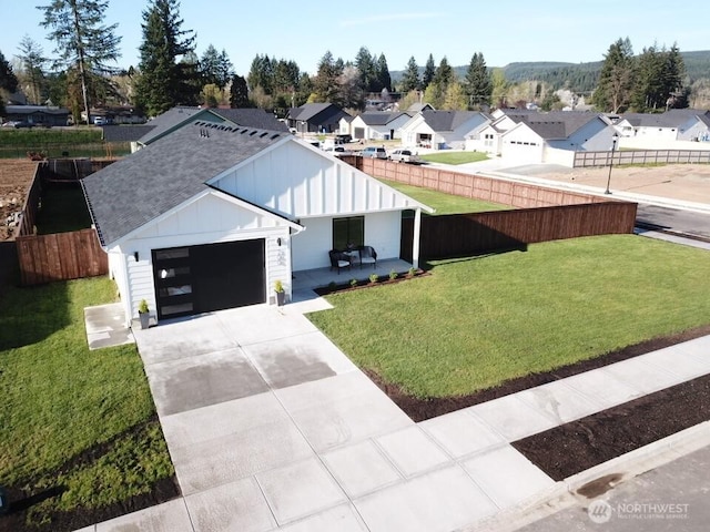 200 W Oak St, Yacolt, WA 98675 - modern inspired farmhouse featuring board and batten siding, a residential view, driveway, a shingled roof, and a garage