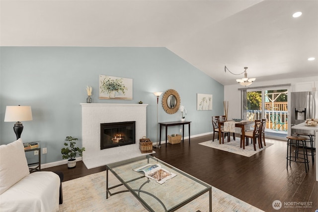 35404 18th Ave SW, Federal Way, WA 99023 - living room featuring vaulted ceiling, wood finished floors, a chandelier, a fireplace, and recessed lighting