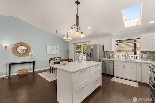 35404 18th Ave SW, Federal Way, WA 99023 - kitchen featuring stainless steel appliances, tasteful backsplash, vaulted ceiling, dark wood-type flooring, and white cabinetry