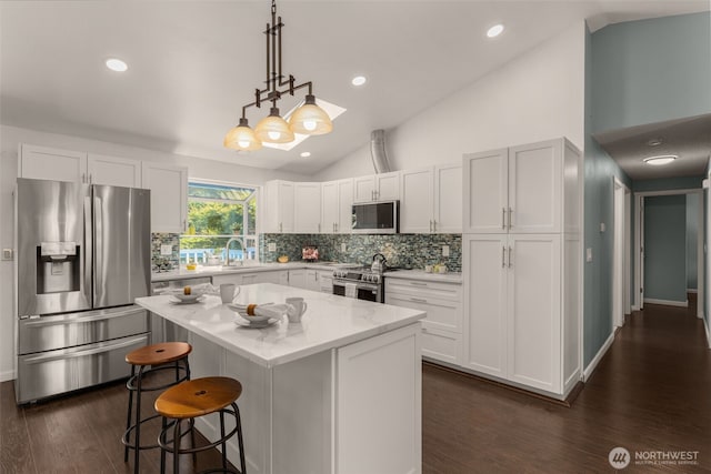 35404 18th Ave SW, Federal Way, WA 99023 - kitchen with stainless steel appliances, decorative backsplash, a center island, a kitchen breakfast bar, and dark wood finished floors
