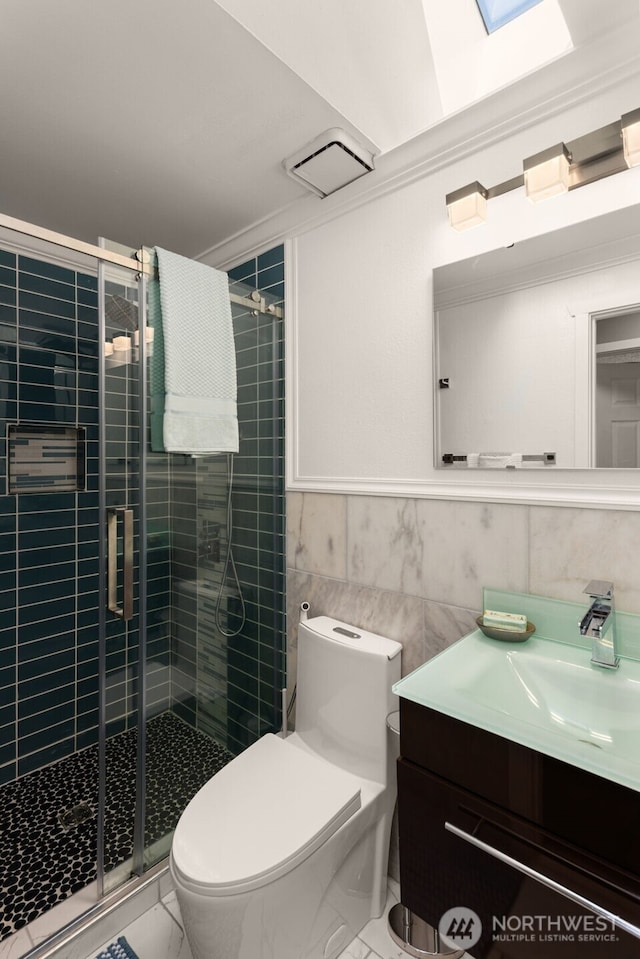 35404 18th Ave SW, Federal Way, WA 99023 - bathroom with vanity, tile walls, a shower stall, marble look tiles, and crown molding