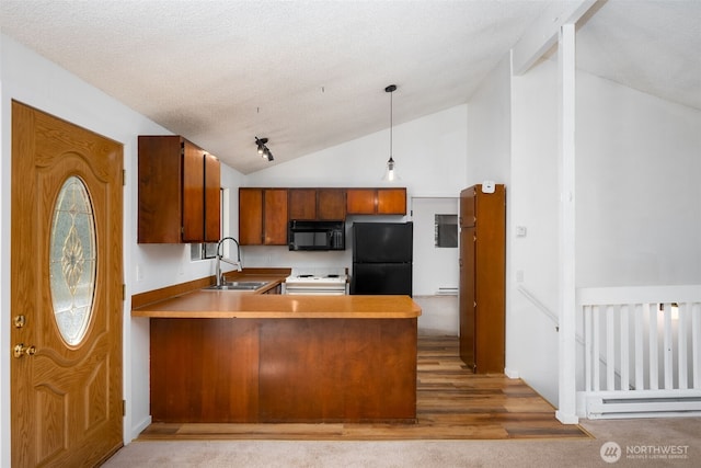 6 Hillside Pl, Bellingham, WA 98229 - kitchen featuring black appliances, a baseboard radiator, a peninsula, brown cabinets, and decorative light fixtures