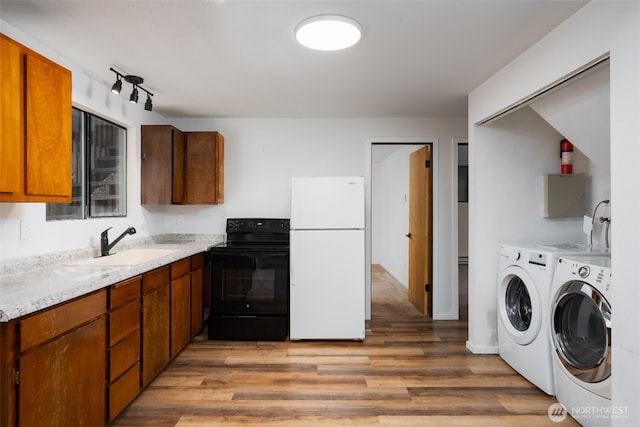 6 Hillside Pl, Bellingham, WA 98229 - kitchen with freestanding refrigerator, electric range, washer and clothes dryer, light countertops, and light wood-style flooring