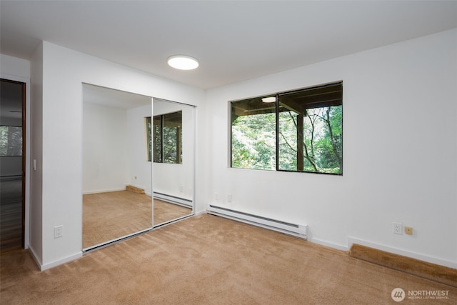 6 Hillside Pl, Bellingham, WA 98229 - unfurnished bedroom with baseboard heating, carpet floors, and a closet