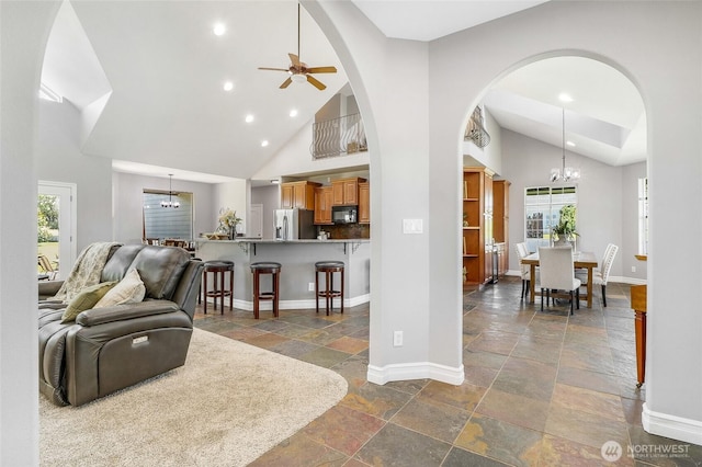10391 Rd 5.6 NE, Moses Lake, WA 98837 - living room featuring a chandelier, stone tile flooring, high vaulted ceiling, recessed lighting, and plenty of natural light