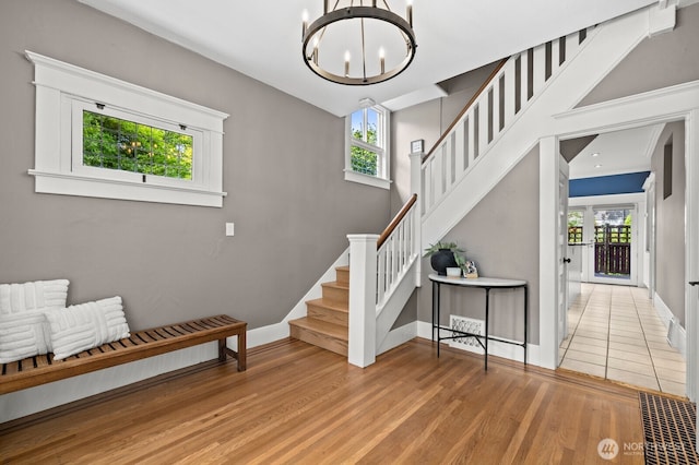 2159 10th Ave W, Seattle, WA 98119 - foyer entrance featuring stairs, a chandelier, and wood finished floors